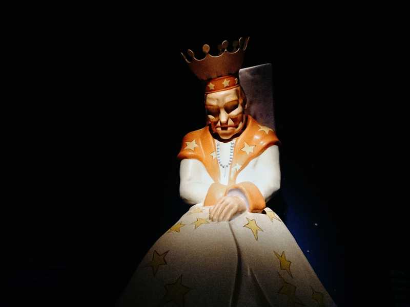 A crowned sculpture of the King from The Little Prince, wearing a star-covered robe at the museum in Hakone, Japan.